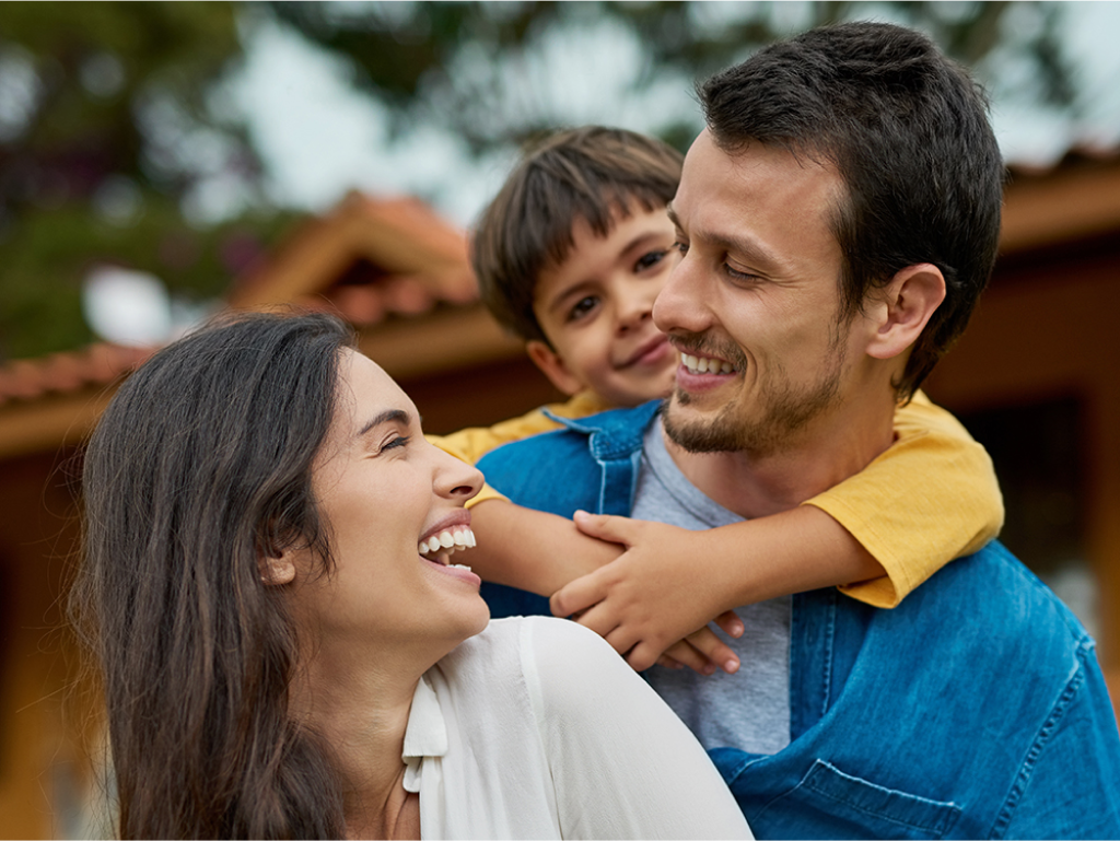 Happy family of three smiling and spending quality time together, enjoying a joyful moment at home