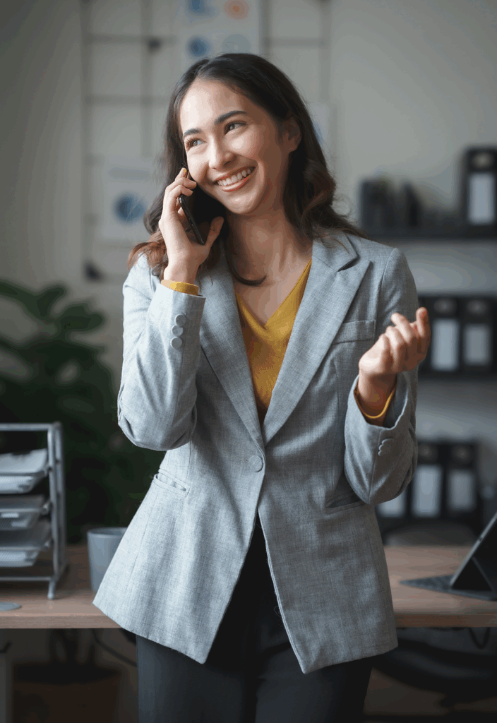 Smiling young woman talking on a phone call, appearing happy and engaged